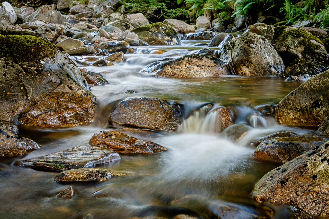 The rocks in Resipole Burn glistening after being covered with fresh rain | Sunart Scotland