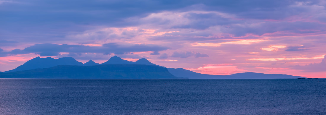 Eigg and Rùm viewed from Samalaman Bay at the end of a late summer sunset when the sky to the north west of them was coloured pink | Moidart Scotland