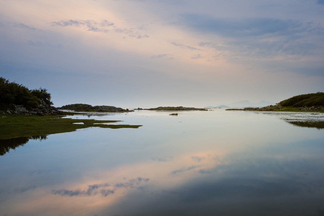A calm sea during a high tide at Portuairk with the Small Isles on the horizon | Ardnamurchan Scotland | Steven Marshall Photography