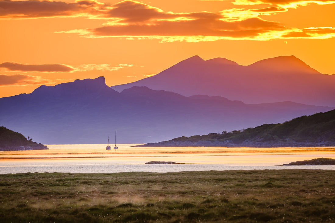 Small Isles of Eigg and Rùm viewed through the entrance to Kentra Bay at sunset | Ardnamurchan Scotland | Steven Marshall Photography