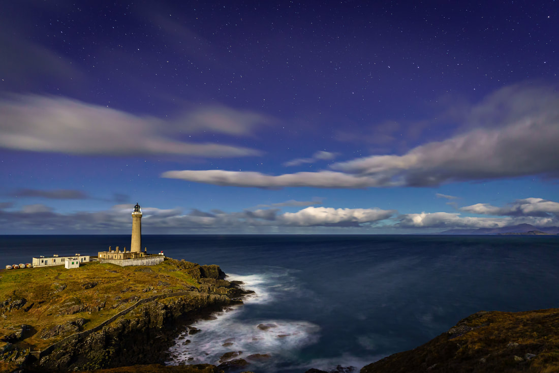 Ardnamurchan Lighthouse lit up by the light moonlight with the stars of The Plough high in the sky above the Small Isles | Ardnamurchan Scotland