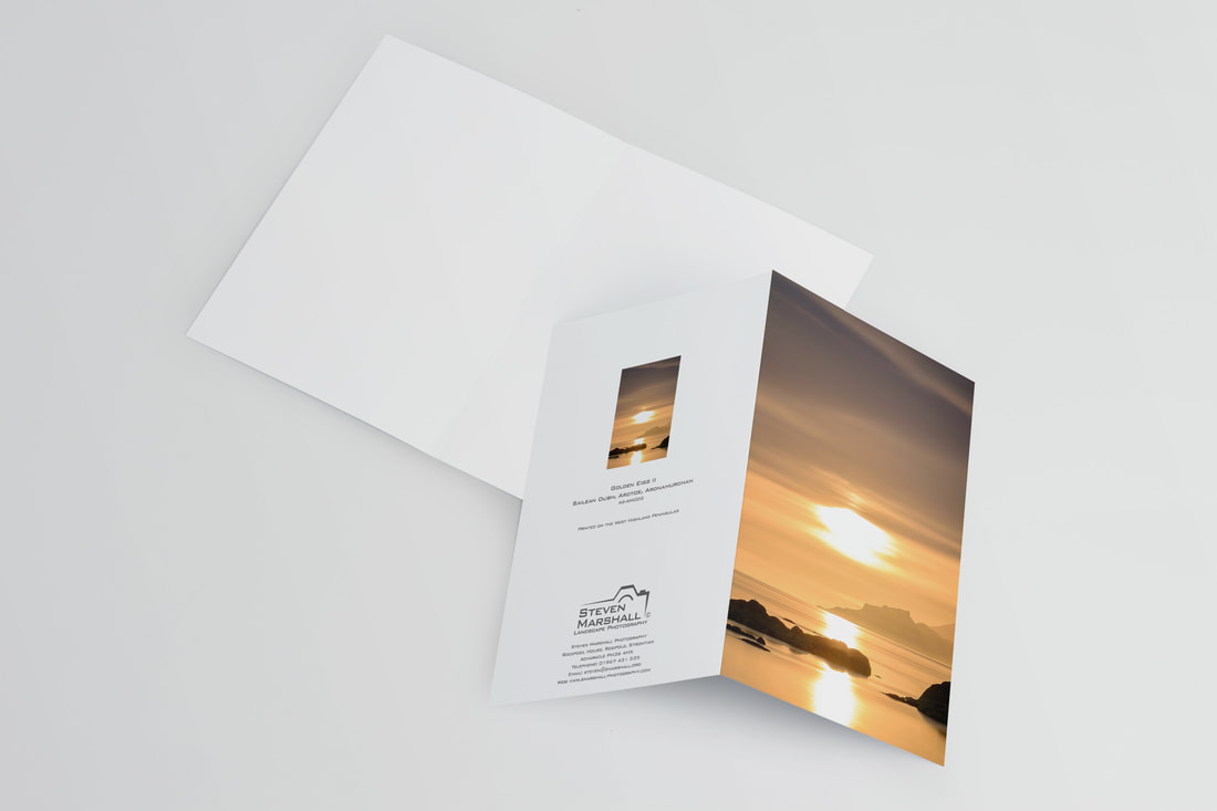 An A6 greeting card featuring a view of the Isle of Eigg from the beach at Ardtoe during a golden sunset | Ardnamurchan Scotland