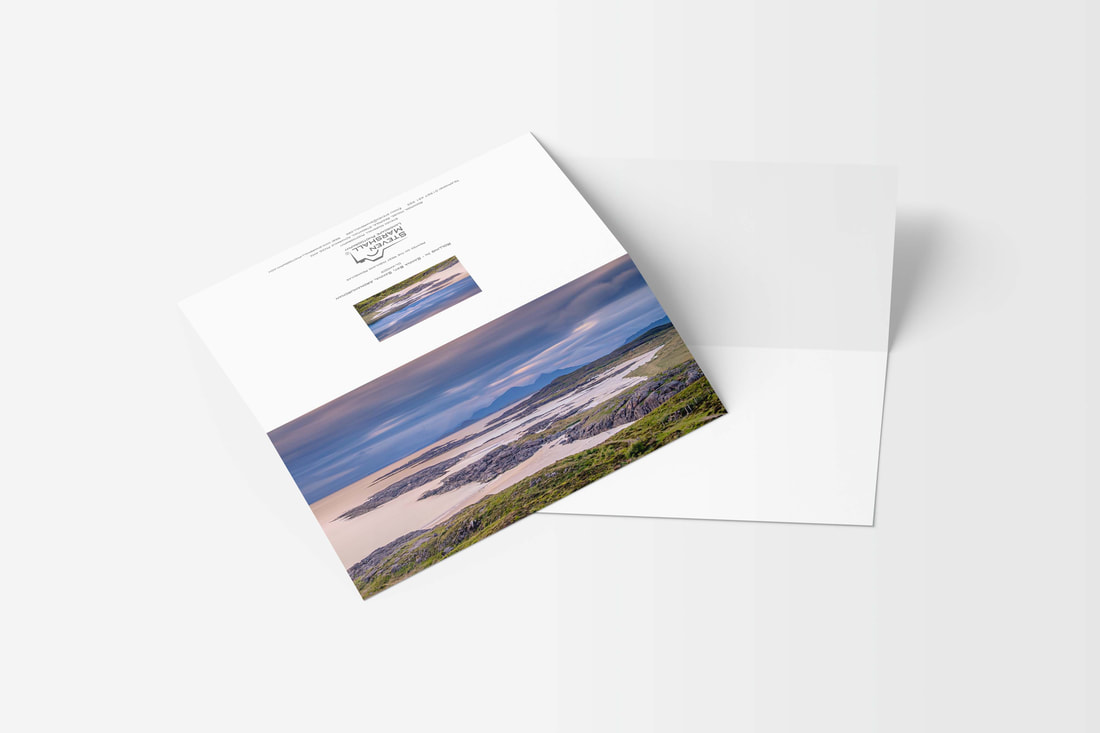 A DL sized greeting card featuring clouds rolling in over Sanna Beach with a small gap in them letting through golden light onto the water and sand | Ardnamurchan Scotland