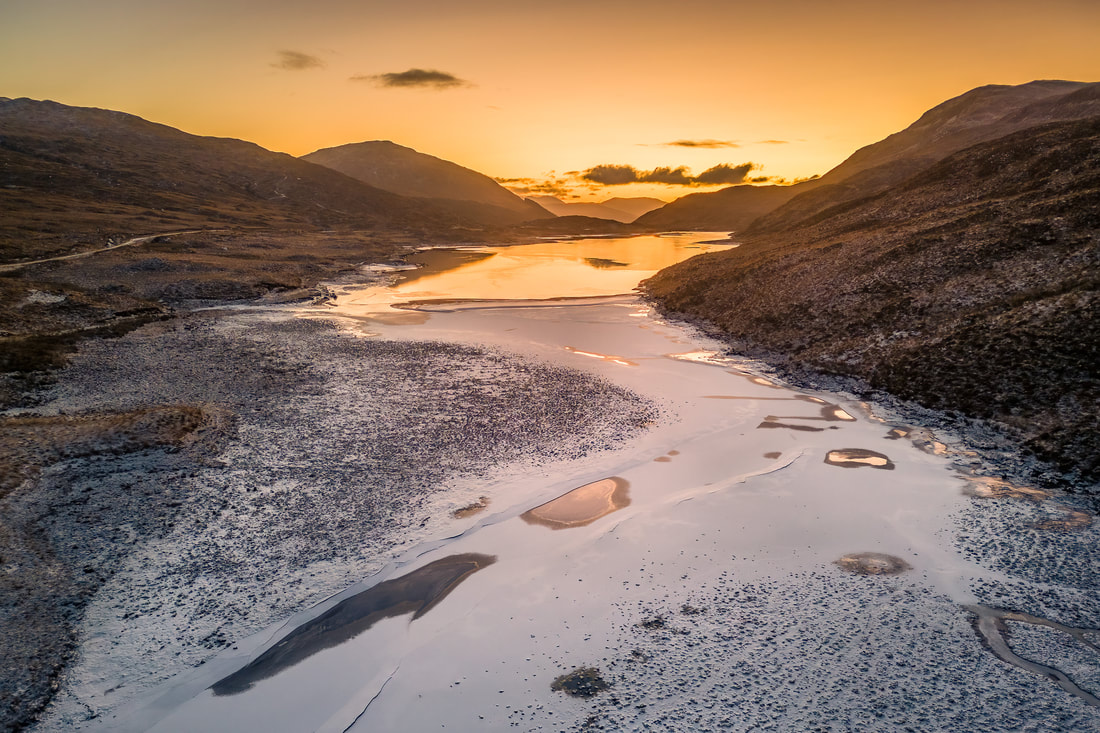 A frozen Loch Uisge at Kingairloch on a winter morning with snow on its surface | Ardgour Scotland | Steven Marshall Photography