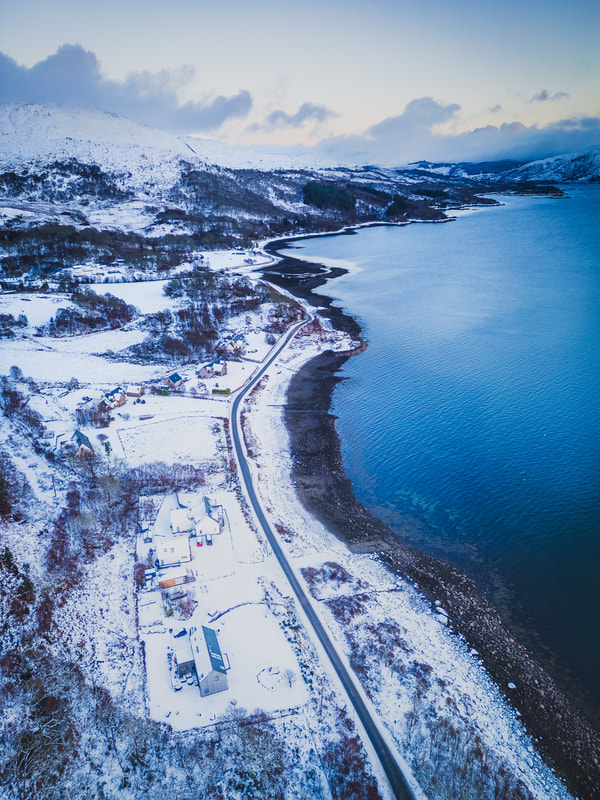 An aerial view of Resipole with snow all the way down to the blue sea | Loch Sunart Scotland | Steven Marshall Photography