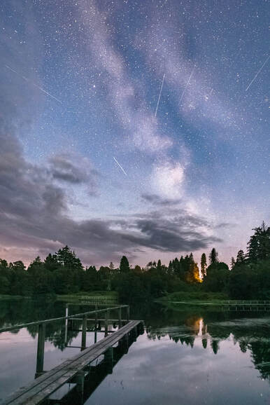 Shooting stars from the α–Capricornid meteor shower streaking across the sky above the River Shiel | Moidart Scotland | Steven Marshall Photography