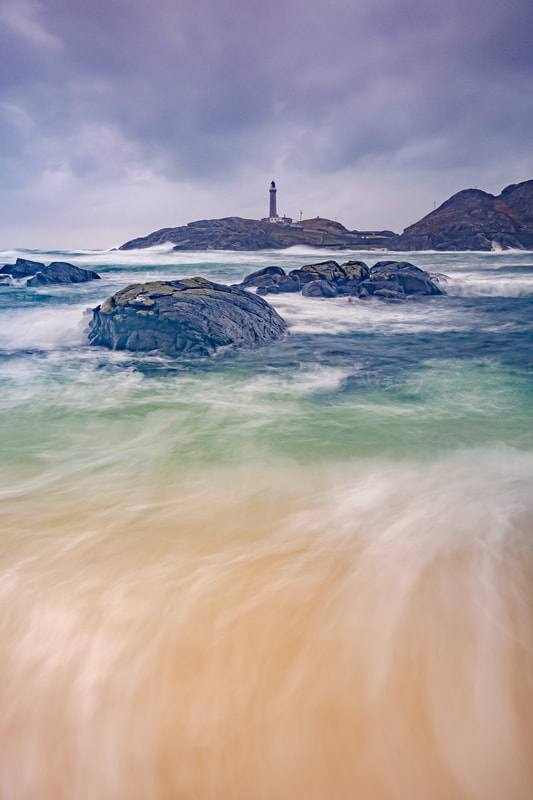 Ardnamurchan Lighthouse on a stormy afternoon with waves crashing into Briaghlann and up the small coral sand beach on Dubh Rubha Mor | Ardnamurchan Scotland