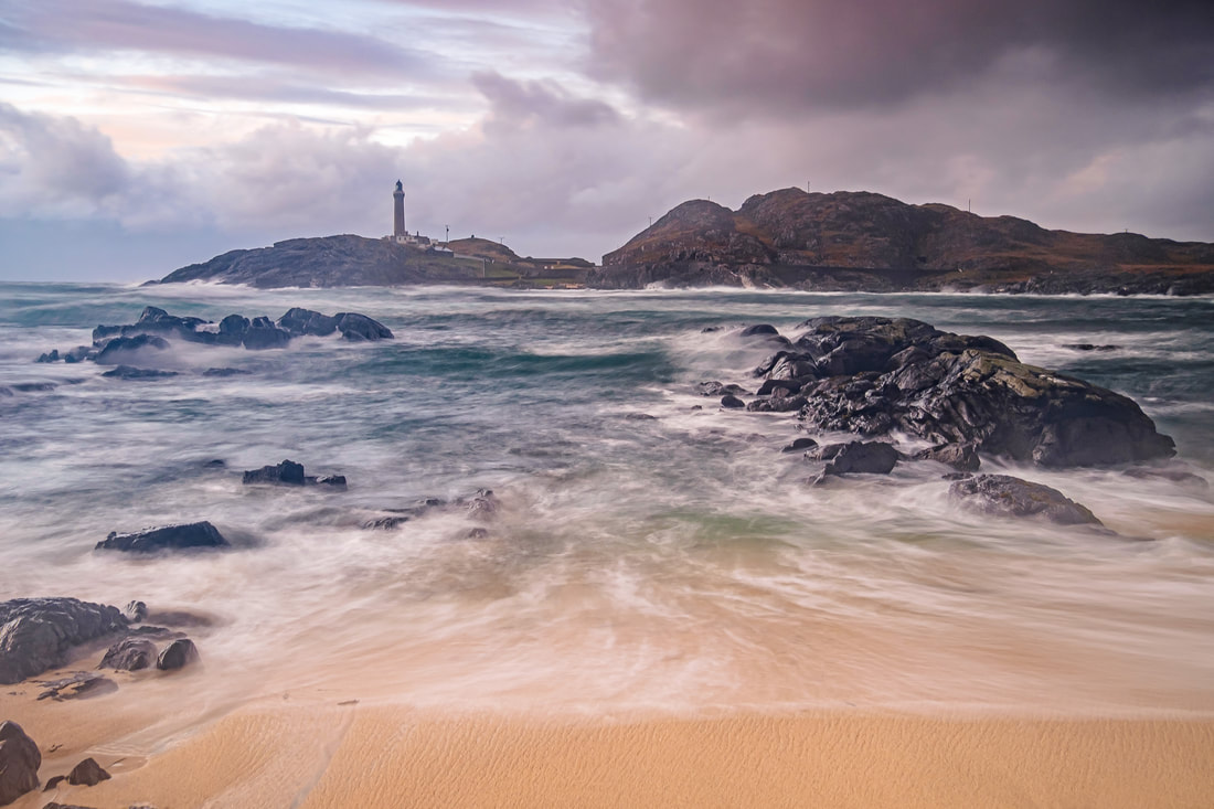 Ardnamurchan Lighthouse on a stormy afternoon with waves crashing into Briaghlann and up the small coral sand beach on Dubh Rubha Mor | Ardnamurchan Scotland