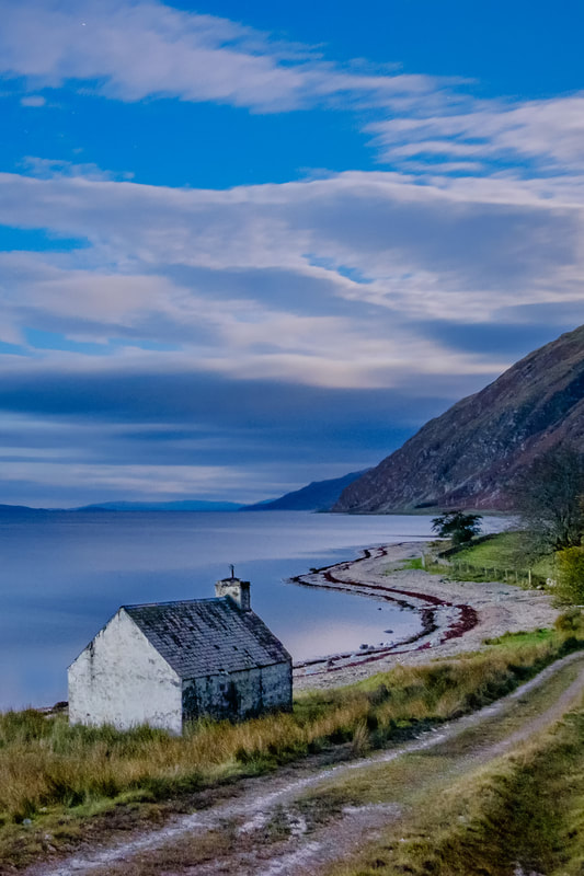 The old bothy that sits between the road and the shore of Loch Linnhe at Kilmalieu, in the blue hour before sunrise | Ardgour Scotland