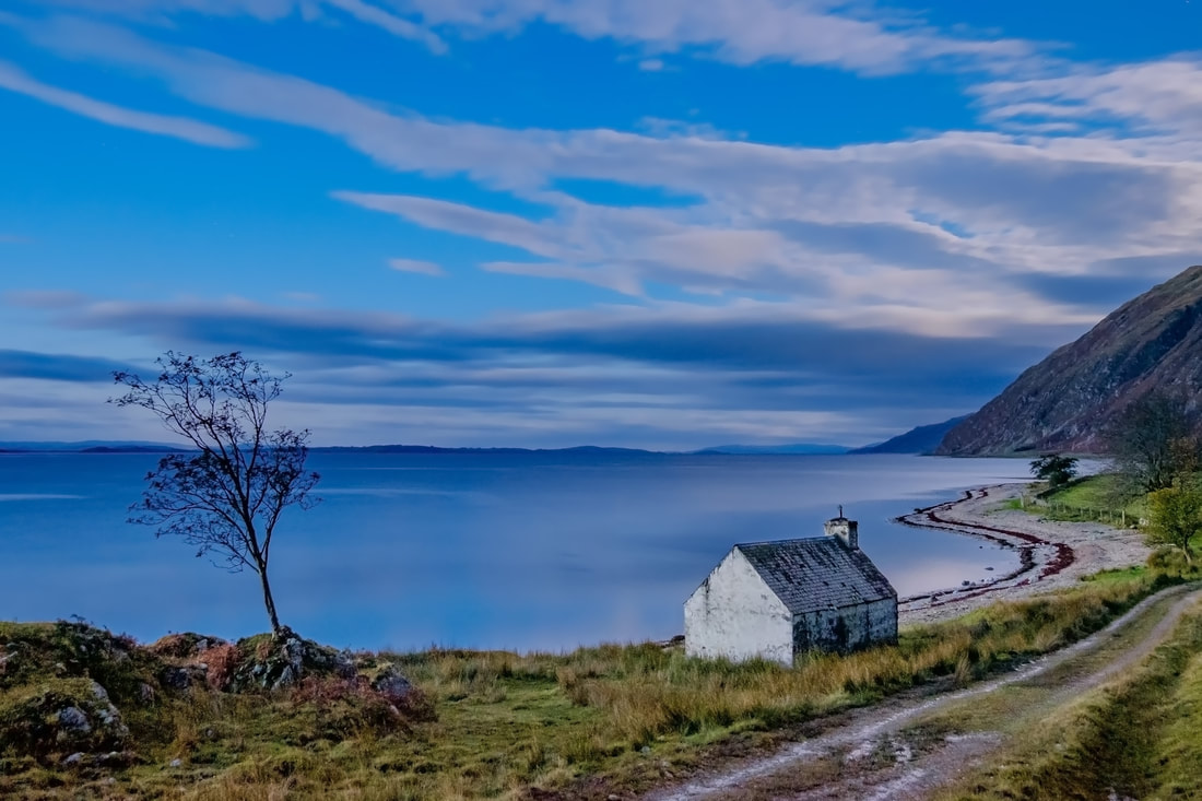 The old bothy that sits between the road and the shore of Loch Linnhe at Kilmalieu, in the blue hour before sunrise | Ardgour Scotland
