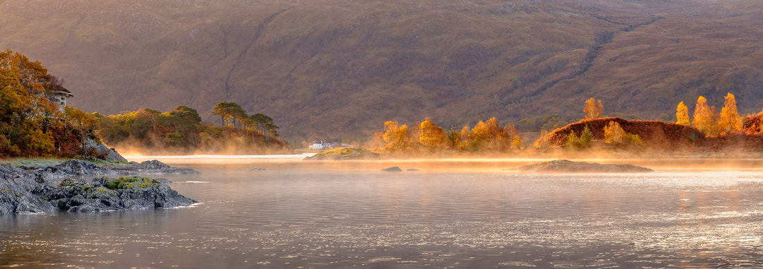 Sunlight on a calm autumn morning warming the surface of Loch Sunart causing mist to rise from it | Sunart Scotland