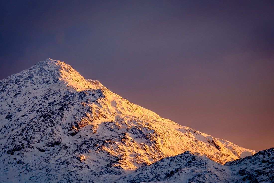 The first light of a late-November day illuminating the snowy peak of Ben Resipole | Sunart Scotland