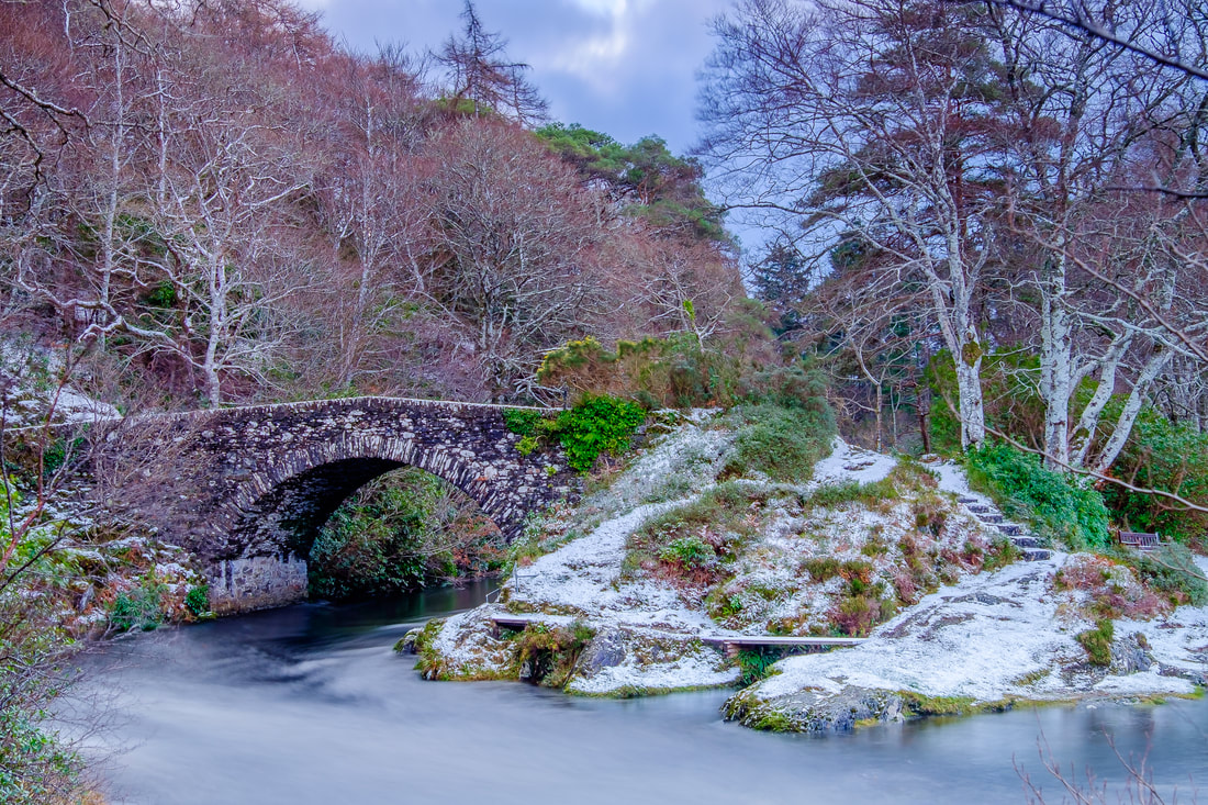 The old Shiel Bridge sits in a landscape covered by a light dusting of snow on an early December afternoon | Moidart Scotland