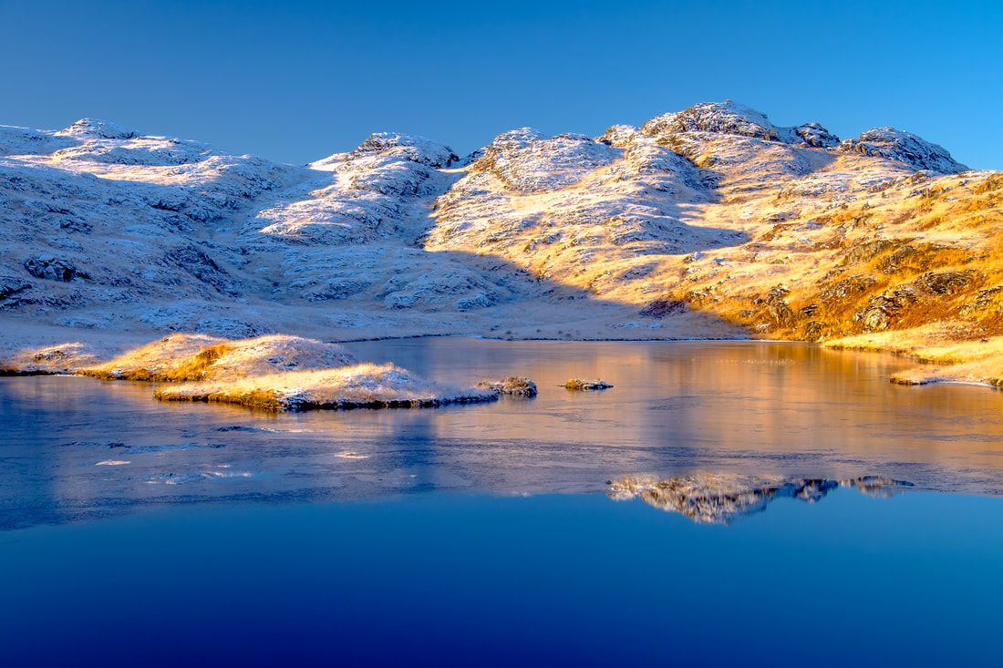 A partially frozen Lochan Blain under clear blue skies on a frosty winter day | Moidart Scotland