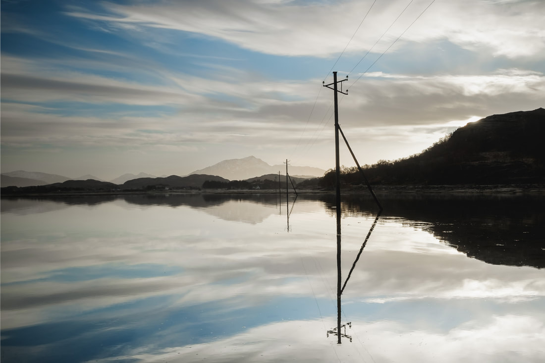 Telegraph poles partly submerged in the sea at Kentra Bay during a high tide | Ardnamurchan Scotland | Steven Marshall Photography