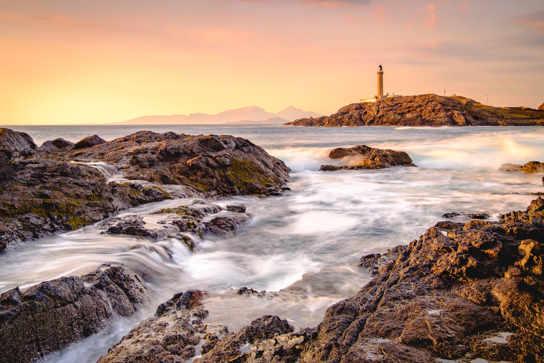 Waves crashing on the rocks of Dubh Rubha Mor with Ardnamurchan Lighthouse in the background | Ardnamurchan Scotland