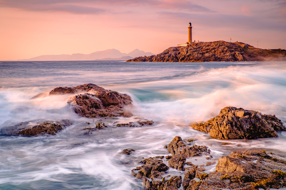 Waves crashing on the rocks of Dubh Rubha Mor with Ardnamurchan Lighthouse in the background | Ardnamurchan Scotland