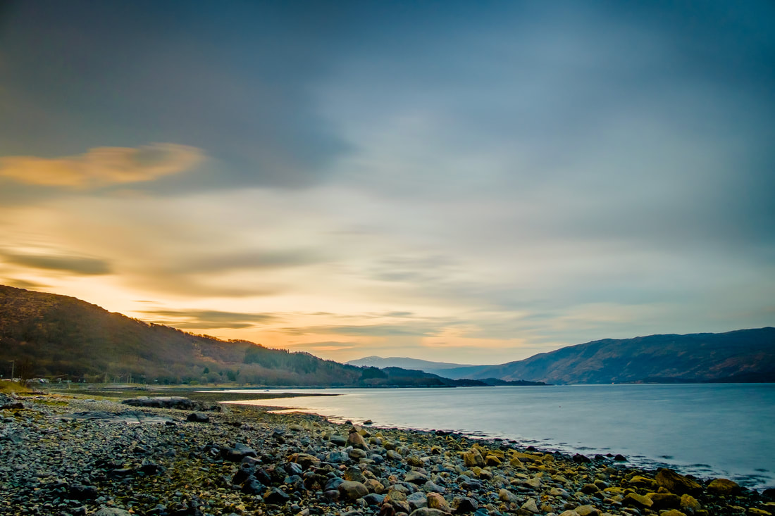 The sun appearing over the hills in the east as a new day by the shore of Loch Sunart arrives | Sunart Scotland