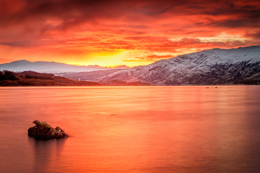 A red and gold winter sunrise over Loch Sunart and the snow-covered hills of Morvern | Sunart Scotland