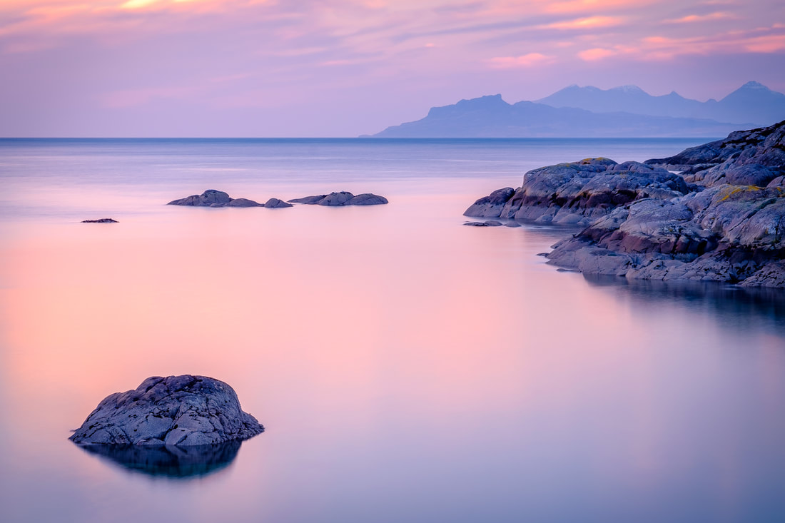 The view of the Small Isles of Eigg and Rùm from Ardtoe under pink evening sky | Ardnamurchan Scotland