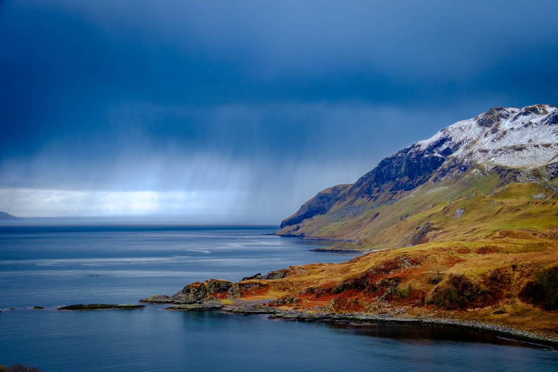 The view of the Sound of Mull from Camas nan Gaell with snow on Ben Hiant and a snow shower approaching | Ardnamurchan Scotland
