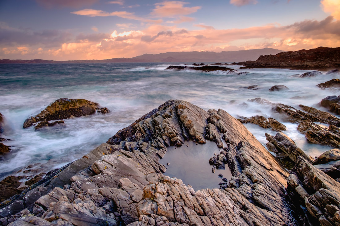 The jagged and rocky coastline at Smirisary on a stormy day with waves crashing upon the shore | Moidart Scotland