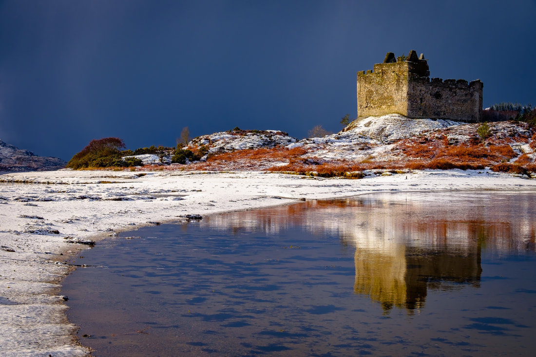 A fresh fall of snow at high tide meeting the sea on the sandbar causeway that leads across to Castle Tioram | Moidart Scotland