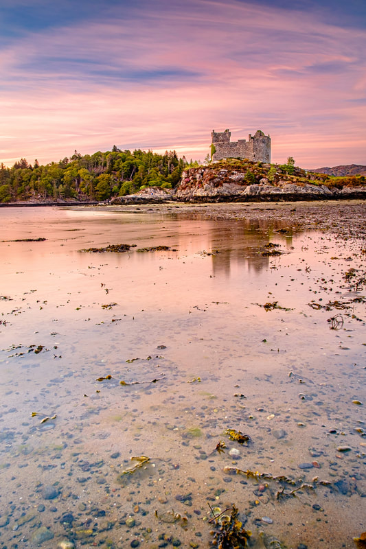 Castle Tioram at low tide under a sky of clouds and sunset pinks | Moidart Scotland