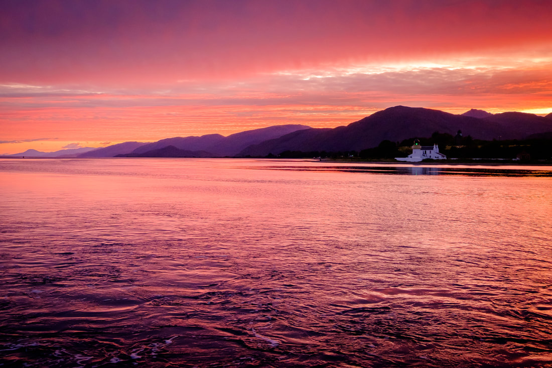 Corran Lighthouse viewed across Loch Linnhe from Nether Lochaber during a spectacular pink sunset | Ardgour Scotland