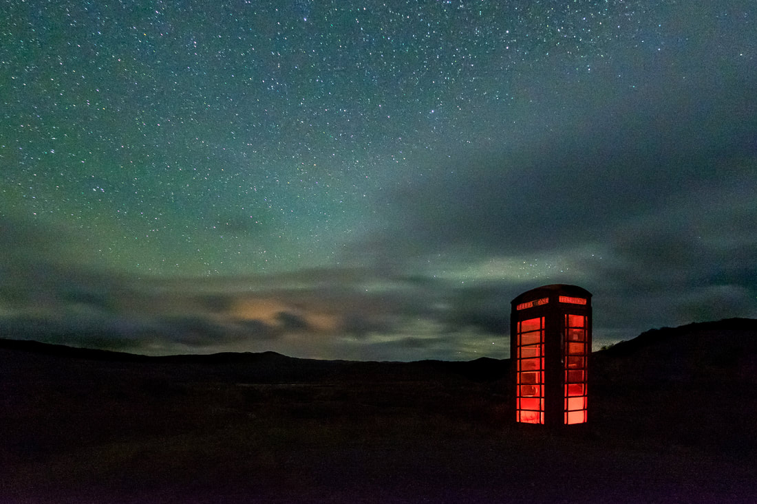 A solitary phone box sitting on Kentra Moss and under the cloud and stars of a cold winter night | Ardnamurchan Scotland