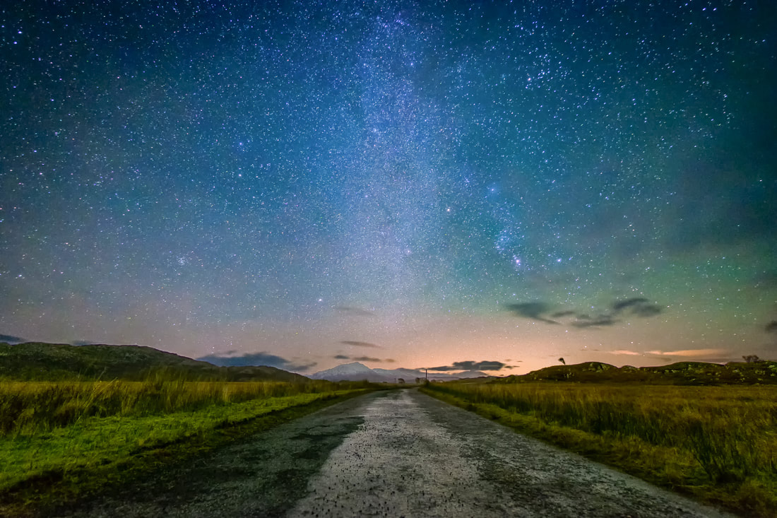 The road from Ardtoe at the Newton of Ardtoe Junction with the Milky Way and a snow-capped Ben Resipole in the distance | Ardnamurchan Scotland