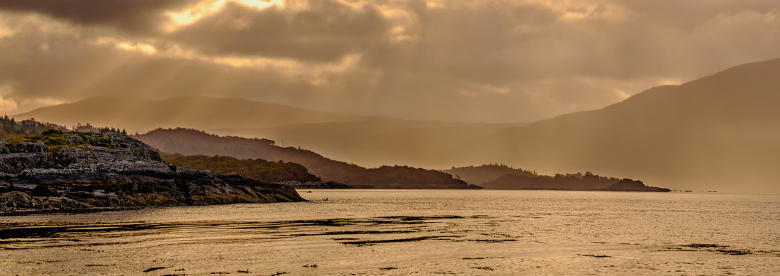 Loch Sunart from Resipole with light breaking through the clouds above headlands that run out into the Loch | Sunart Scotland