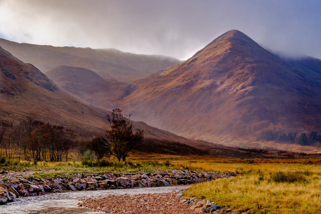 Light breaking through the clouds to light up the slopes of Meall na h-Iolaire that sits beneath the mountain of Beul Choire nan Each | Ardgour Scotland