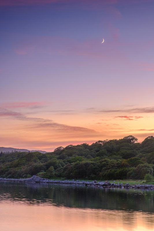 A crescent moon above Loch Sunart in the twilight of a midsummer evening | Sunart Scotland | Steven Marshall Photography