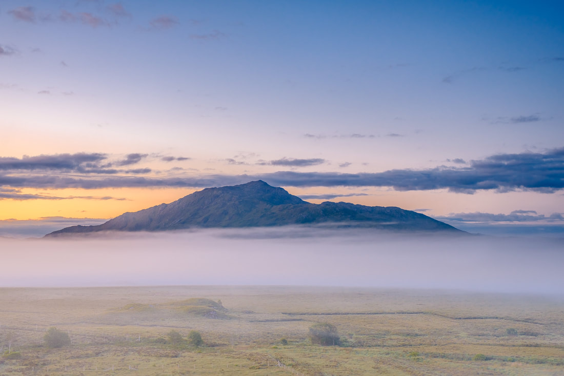 Pre-dawn on a midsummer morning with mist drifting across the moss at Mingarry and shrouding the lower slopes of Ben Resipole | Moidart Scotland
