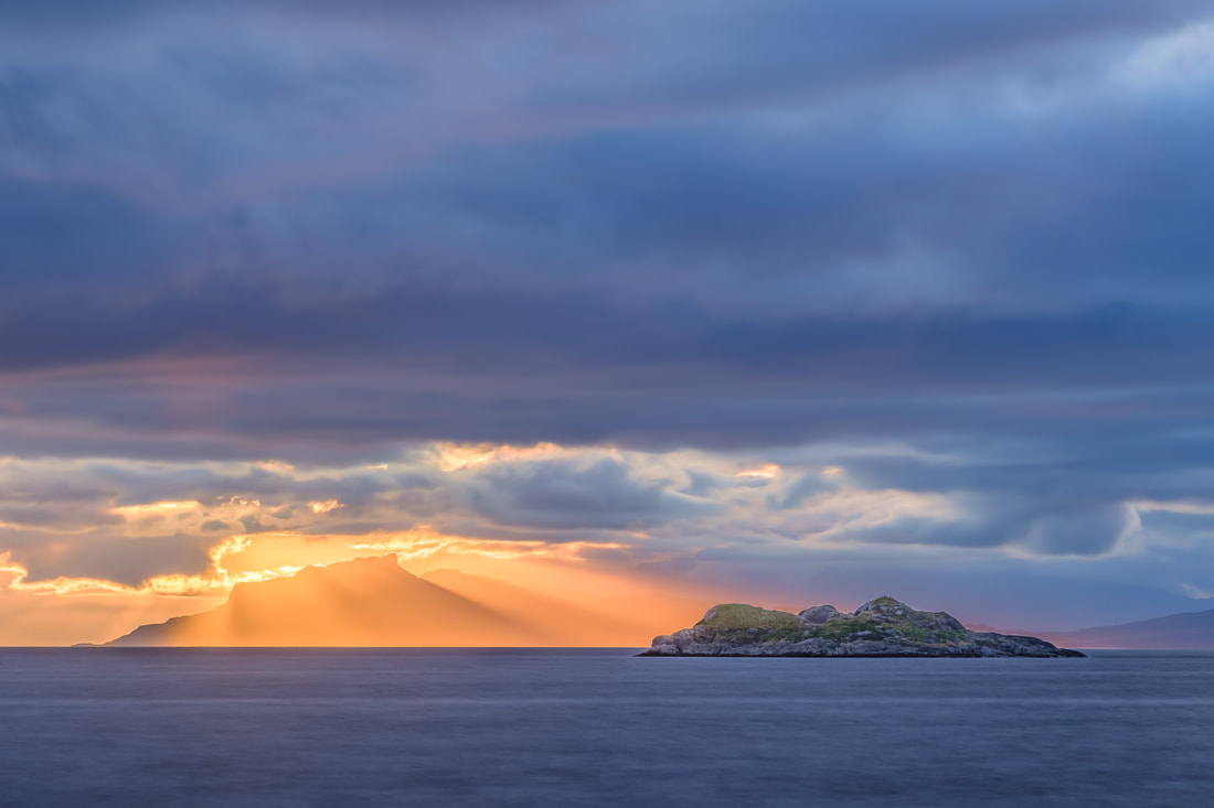 Stunning July sunset at Ardtoe with crepuscular rays shining down on the Isle of Eigg | Ardnamurchan Scotland