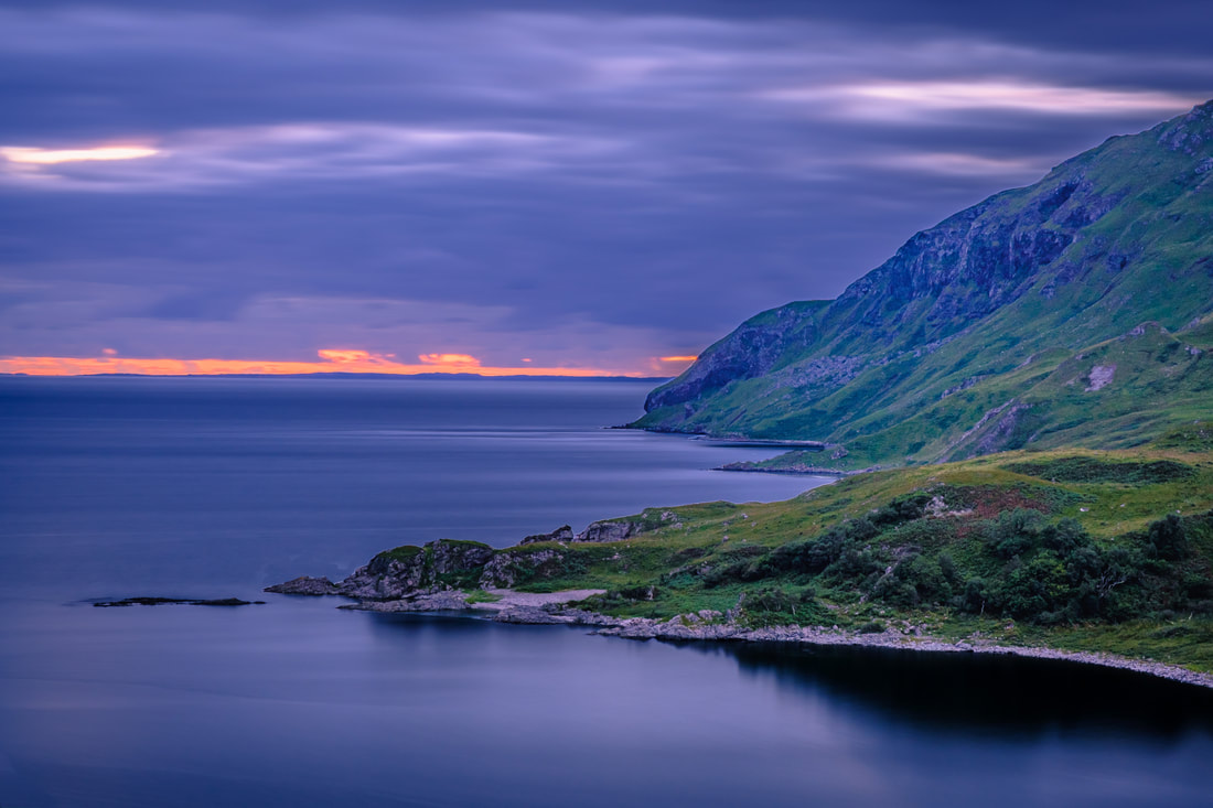 Remnants of sunset red lingering on the horizon beyond Maclean’s Nose as dusk falls on the coastline to the west of Camas nan Geal | Ardnamurchan Scotland