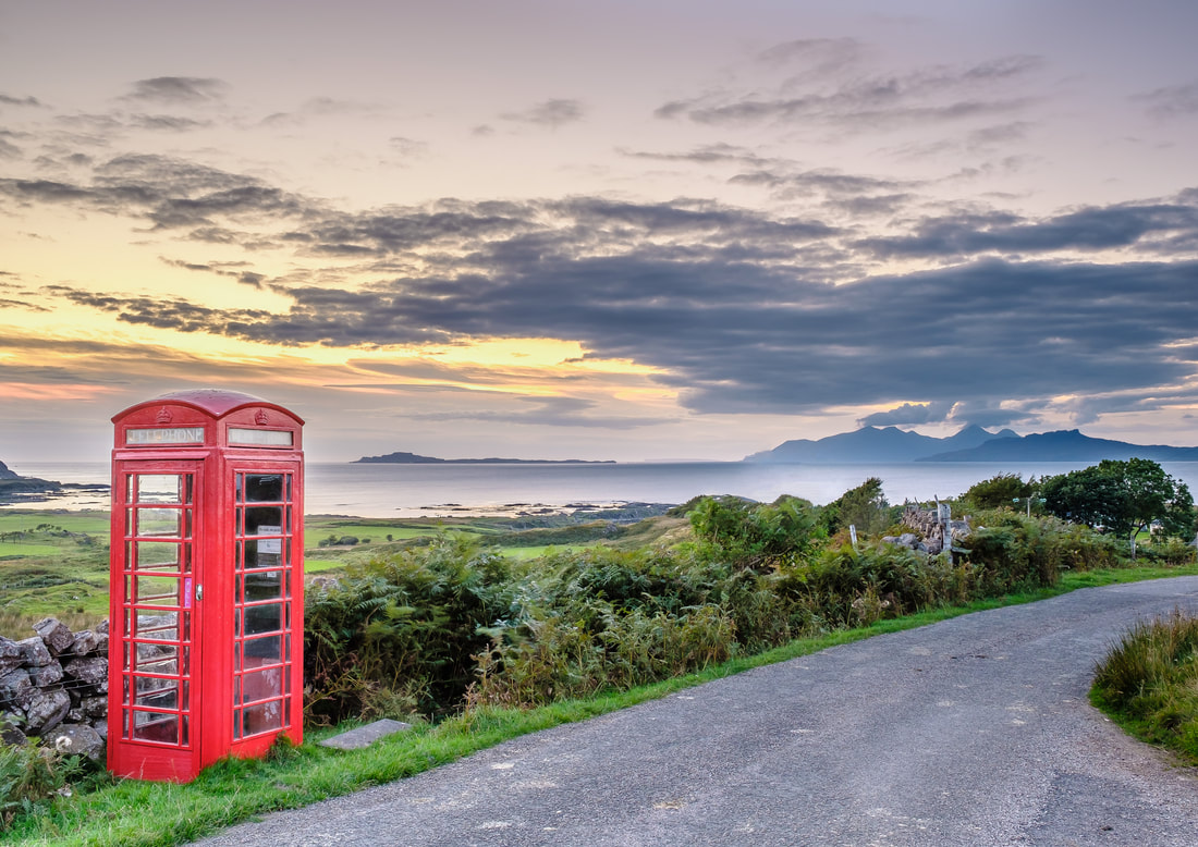 Freshly painted Kilmory phone box set against a backdrop of the Small Isles of Muck, Eigg and Rùm at dusk on a late summer evening. | Ardnamurchan Scotland