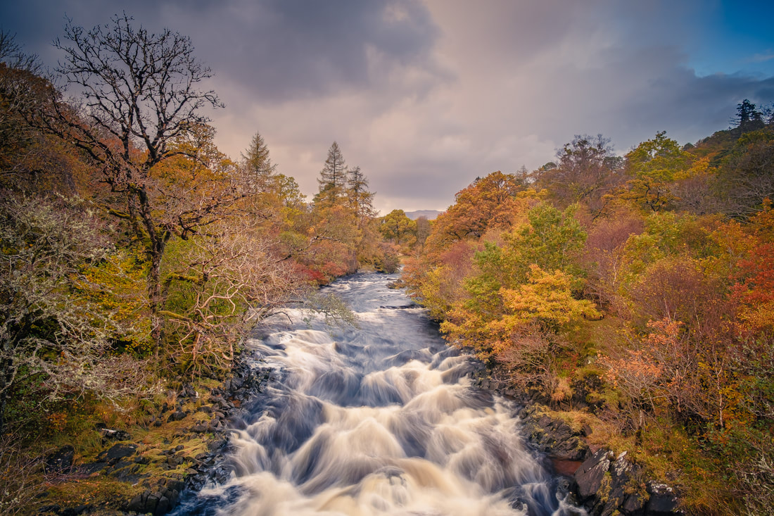 The River Aline in full spate following Autumn rain, flowing over the rapids and beneath the Ivy Bridge at Kinlochaline | Morvern Scotland