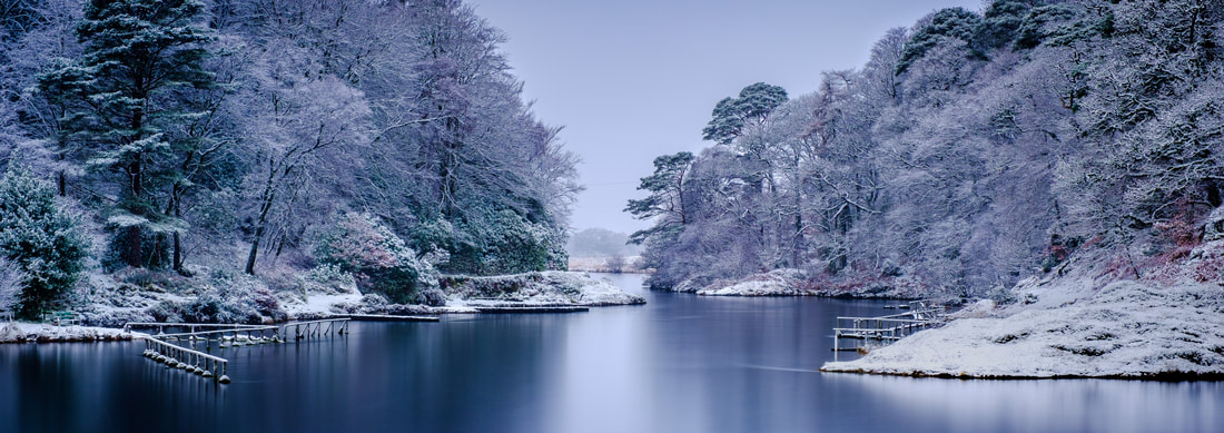 The River Shiel with a fresh fall of overnight snow covering the branches of the trees on its banks and the steely blue of the morning colouring the river’s surface | Moidart Scotland