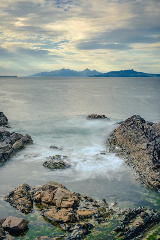 The rocky shore of Fascadale Bay with the Small Isles of Eigg and Rùm beyond | Ardnamurchan Scotland