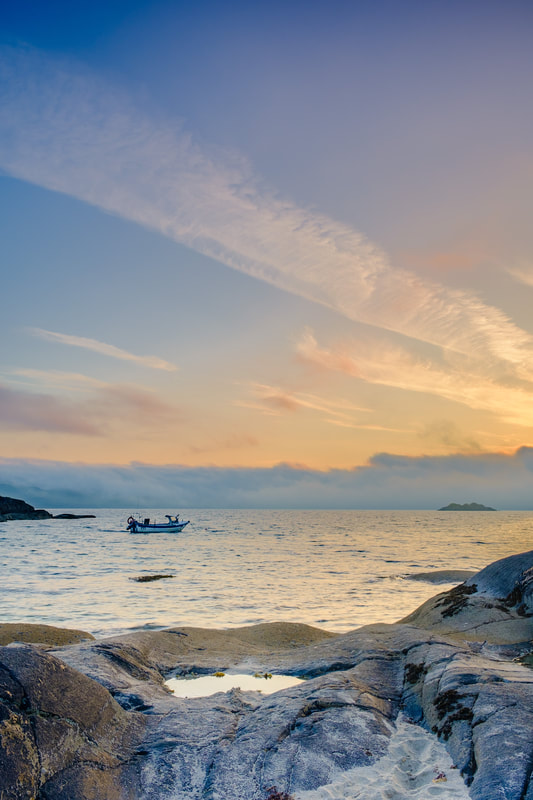 A fishing boat moored off the rocks at Ardtoe with sea mist on the horizon | Ardnamurchan Scotland | Steven Marshall Photography