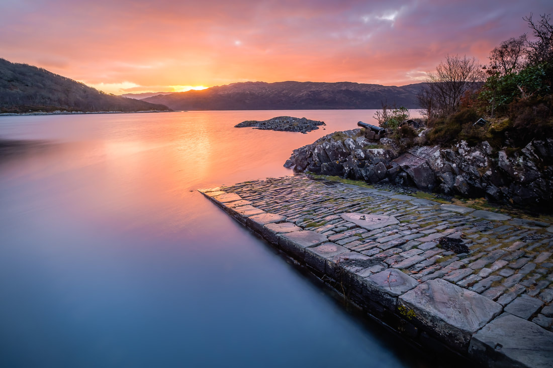 The Salen Jetty at sunrise on a calm January morning with red and yellow colours on Loch Sunart | Ardnamurchan Scotland | Steven Marshall Photography