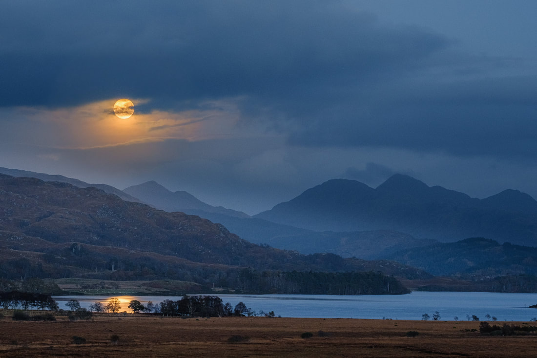 The second full moon of October 2020, a Hunter’s Blue Moon, rising over the summit of Càrn na Nathrach and lighting up the surface of Loch Shiel | Moidart Scotland
