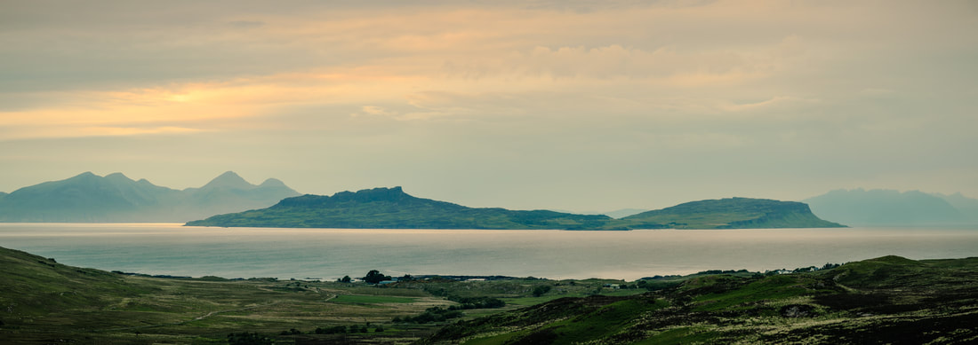 The sun breaking through the cloud to illuminate the Isle of Eigg at dusk | Ardnamurchan Scotland | Steven Marshall Photography