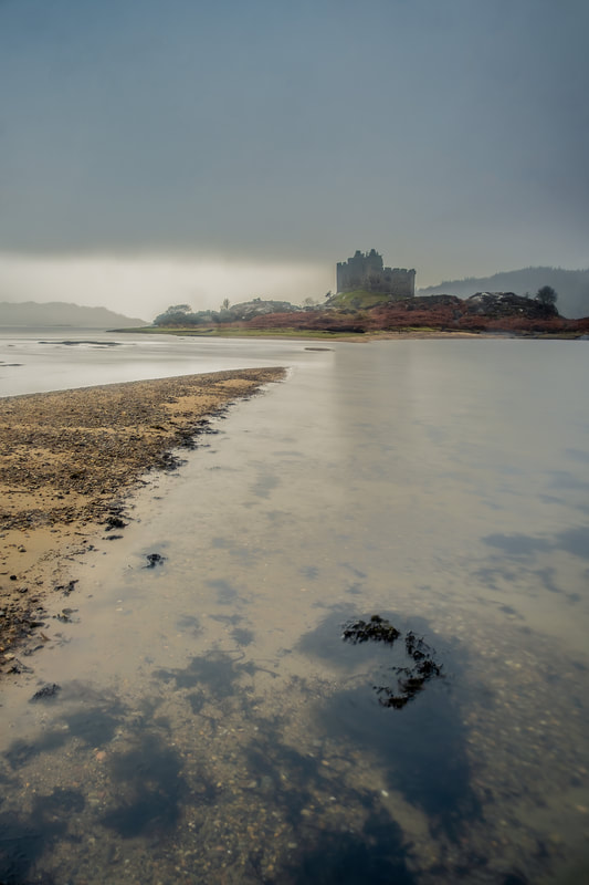 Castle Tioram on an overcast morning with light breaking through the cloud above Loch Moidart | Moidart Scotland | Steven Marshall Photography