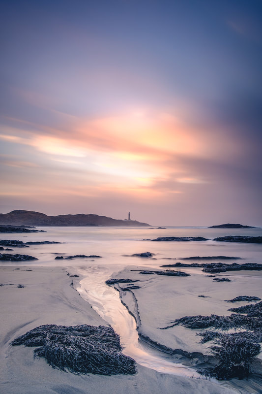 Ardnamurchan Lighthouse against the backdrop of an orange sky | Ardnamurchan Scotland | Steven Marshall Photography