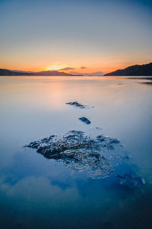 The sun setting beyond the North Channel of Loch Moidart with seaweed in the foreground | Moidart Scotland | Steven Marshall Photography