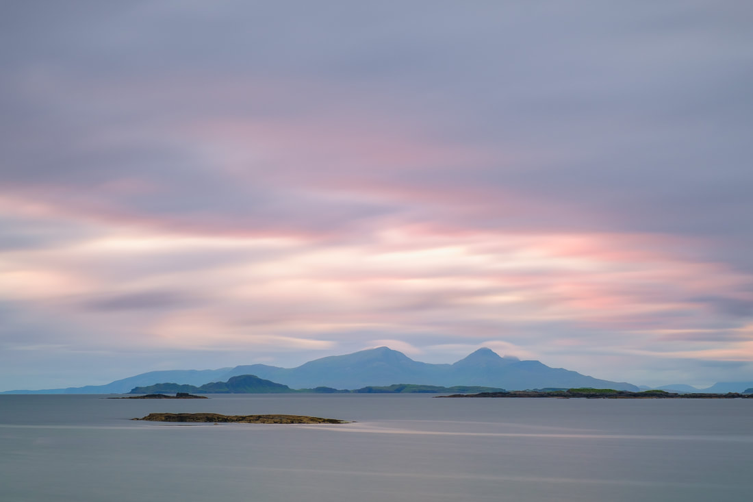 Long exposure shot of the Small Isles of Muck and Rùm viewed across Sanna Bay from Portuairk at sunset when pink mixes with grey in the sky | Ardnamurchan Scotland | Steven Marshall Photography
