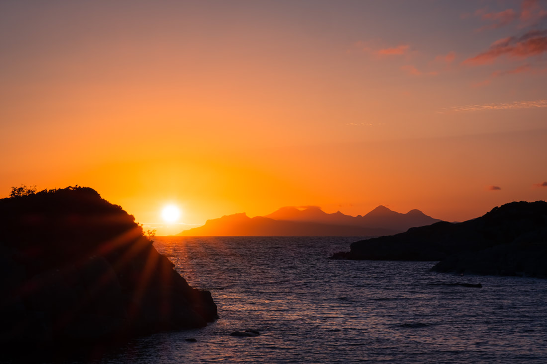 A sunburst close to the Isle of Eigg viewed from Ardtoe | Ardnamurchan Scotland | Steven Marshall Photography